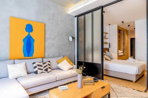 a living room with a couch and a bed at Stayhere Casablanca - Gauthier 1 - Modern Residence in Casablanca