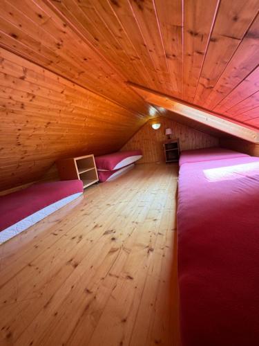 a room with two beds and a wooden floor at bouda Pod Sněžkou in Pec pod Sněžkou