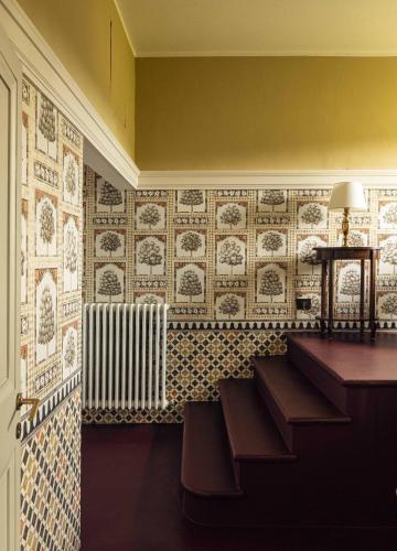 a room with a tile wall with a radiator at Hotel Certosa Di Maggiano in Siena