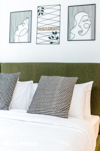 a white bed with black and white pillows at Stayhere Casablanca - Gauthier 1 - Modern Residence in Casablanca