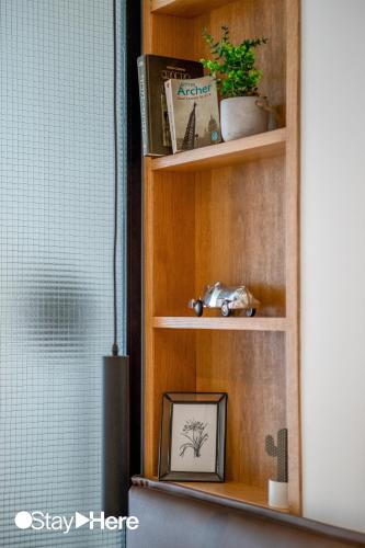a book shelf with a picture of a plant on it at Stayhere Casablanca - Gauthier 1 - Modern Residence in Casablanca