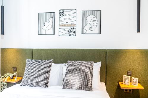 a bedroom with a bed with three pictures above it at Stayhere Casablanca - Gauthier 1 - Modern Residence in Casablanca