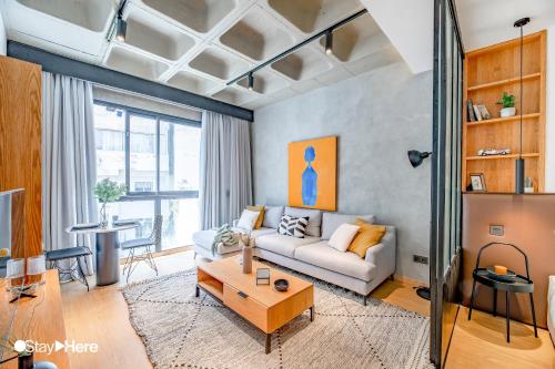 a living room with a couch and a table at Stayhere Casablanca - Gauthier 1 - Modern Residence in Casablanca