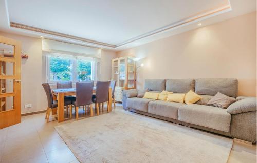 a living room with a couch and a table at 3 Bedroom Stunning Home In Miami Platja in Miami Platja