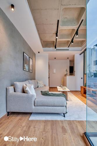 a living room with a couch and a table at Stayhere Casablanca - Gauthier 1 - Modern Residence in Casablanca