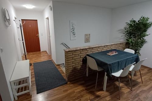 a dining room with a table and chairs and a brick wall at Werkswohnnung Heide Süderholm in Heide