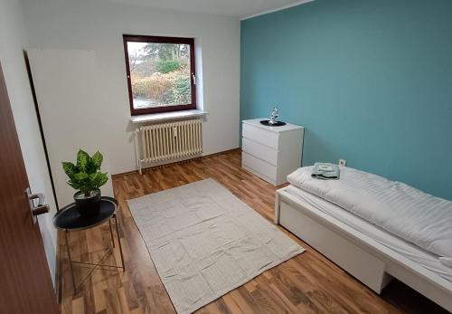 a bedroom with a white bed and a window at Werkswohnnung Heide Süderholm in Heide