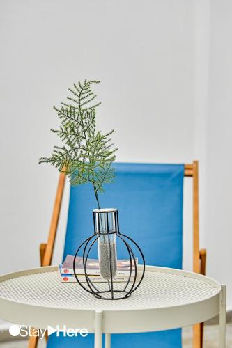a plant in a vase sitting on top of a table at Stayhere Casablanca - Gauthier 1 - Modern Residence in Casablanca