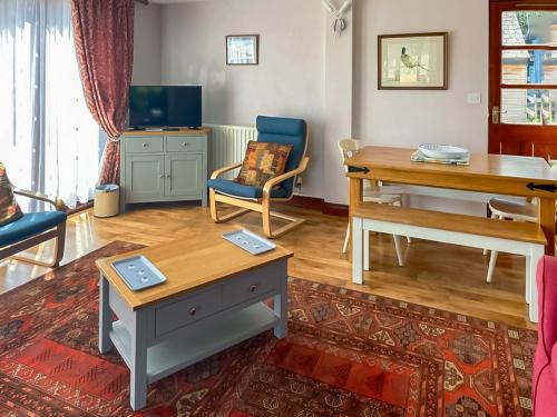 a living room with a desk and a table and chairs at Pheasant in Welney