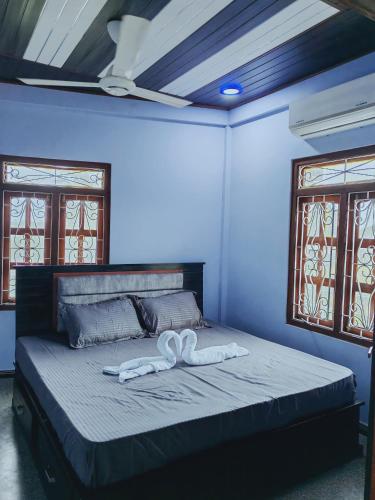 a bedroom with a bed with a white bow on it at Marutham Farm House in Jaffna