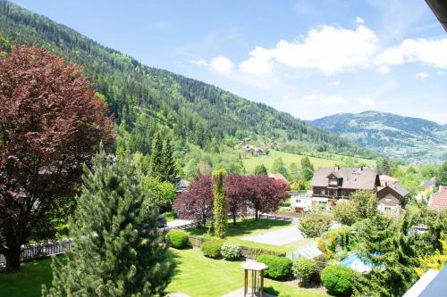 a view of a yard with trees and a house at Ferienwohnung Klamberghof in Feld am See