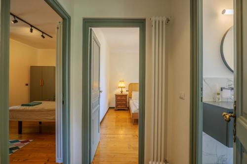 a hallway leading to a bedroom with a bed at Villa Spa Dalia in Cannobio