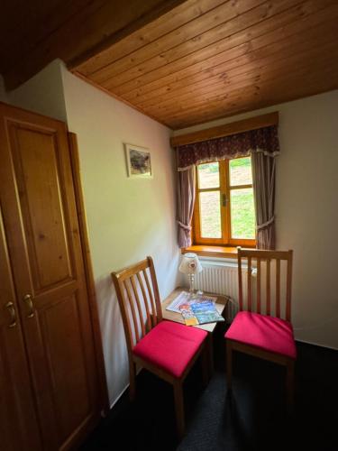 a room with two chairs and a table with a window at bouda Pod Sněžkou in Pec pod Sněžkou