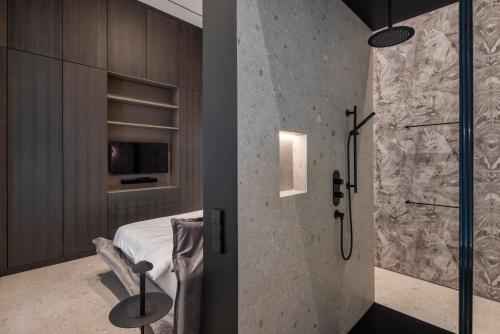 Łazienka z prysznicem, łóżkiem i szklanymi drzwiami w obiekcie City Center Telegraph Apartment w Wiedniu