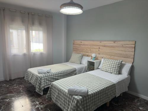 a room with two beds and a chair in it at La Roca in Losa del Obispo