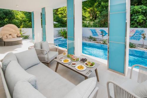 a living room with a white couch and a table at pool villa Sanrriott Okinawa Motobu in Motobu