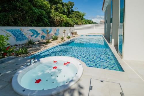 a bathroom sink in front of a swimming pool at pool villa Sanrriott Okinawa Motobu in Motobu