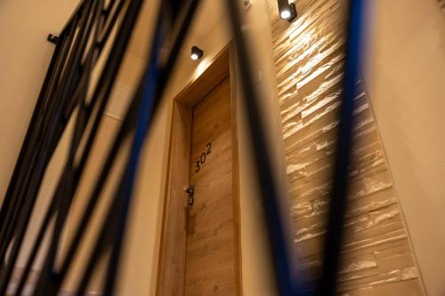 a wooden door in a building with lights on it at Bed & Breakfast Adelsberg Inn in Postojna