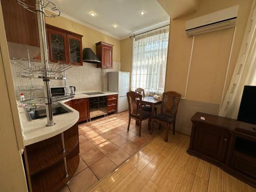 a kitchen with a table and a dining room at Апартаменты на Назарбаева 44 in Karagandy