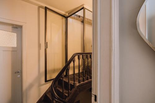 a staircase in a room with a mirror at Burgstraat 8 in Ghent