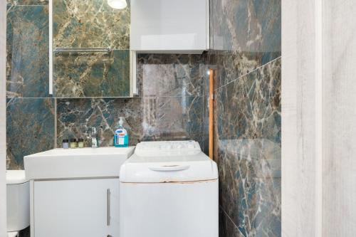 a bathroom with a toilet and a sink at Studio Fourni in Driopis in Dhriopís
