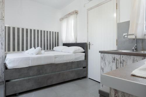 a bedroom with a bed and a sink at Studio Fourni in Driopis in Dhriopís