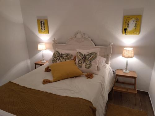 a bedroom with a bed with butterflies on it at Casa da Lameira in Vilar do Ruivo
