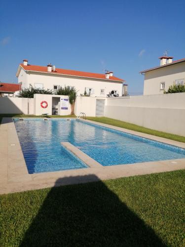 a swimming pool in the yard of a house at Sunny Ofir in Fão
