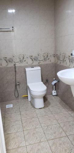 a bathroom with a toilet and a sink at استوديو للايجار in Salalah