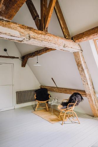 two chairs and a table in a room at Burgstraat 8 in Ghent