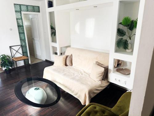 a living room with a couch and a table at Juicy Private Apartments with Jacuzzi in Szentendre