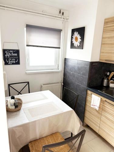 a kitchen with a white table and a window at Juicy Private Apartments with Jacuzzi in Szentendre