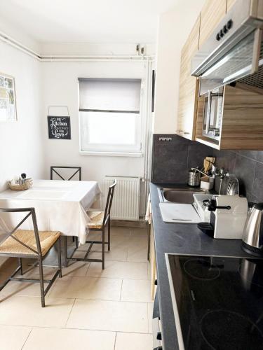 a kitchen with a table and a dining room at Juicy Private Apartments with Jacuzzi in Szentendre
