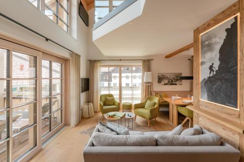 a living room with a couch and a table at Penthouse No9 in Oberstaufen