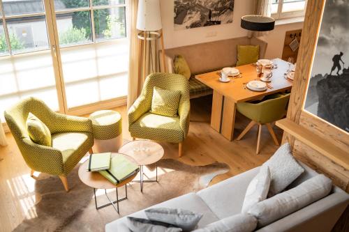 a living room with a table and chairs at Penthouse No9 in Oberstaufen