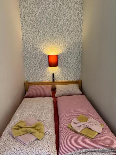 a small bedroom with two beds with towels on them at bouda Pod Sněžkou in Pec pod Sněžkou