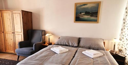 a bedroom with a bed with two towels on it at Hotel Modřín in Pec pod Sněžkou