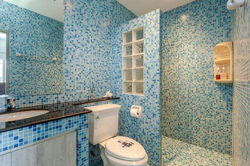 a blue tiled bathroom with a toilet and a sink at Kevin's Pool Villa at Chiang Mai - 4BDR 4Bath Airport & Old City 5min in Chiang Mai