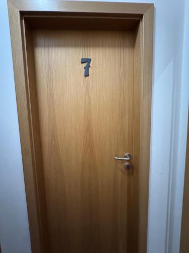 a wooden door with the number seven on it at bouda Pod Sněžkou in Pec pod Sněžkou