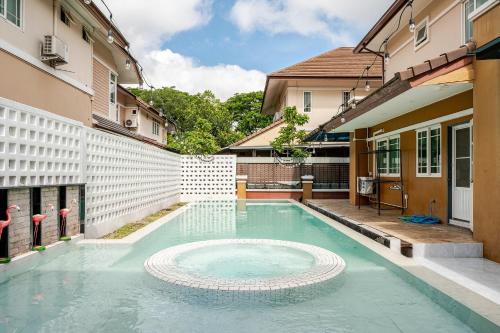 a swimming pool in the middle of a building at Kevin's Pool Villa at Chiang Mai - 4BDR 4Bath Airport & Old City 5min in Chiang Mai