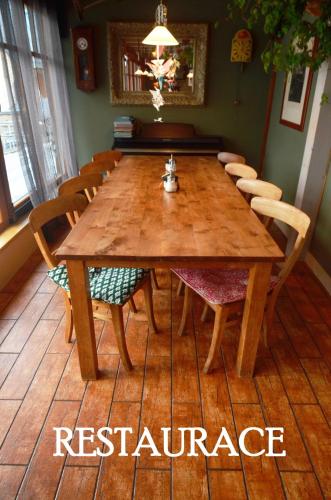 a wooden table and chairs in a room at Hotel Modřín in Pec pod Sněžkou