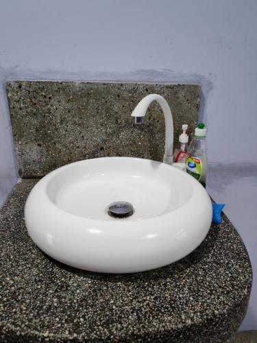 a white sink with a faucet on a counter at Marutham Farm House in Jaffna