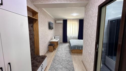 a small room with a bedroom and a bed at УЮТ отель и хостел in Jalal-Abad