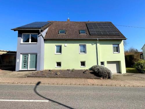 a house with solar panels on the side of the street at Ferienhaus Haus Auenland in Nohfelden