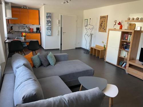 a living room with a couch and a kitchen at Ferienhaus Haus Auenland in Nohfelden