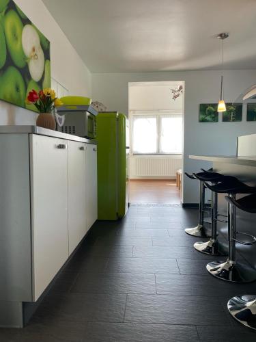 a kitchen with white cabinets and a green refrigerator at Ferienhaus Haus Auenland in Nohfelden
