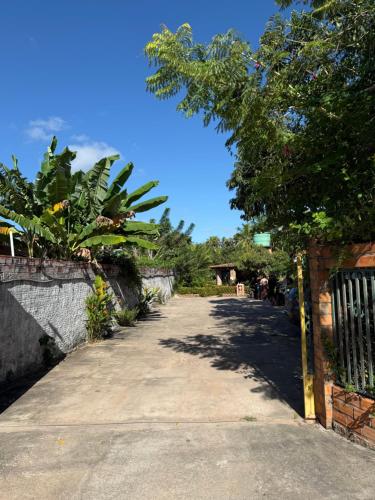 a street with a tree and a brick fence at Pousada do Riacho in Barreirinhas