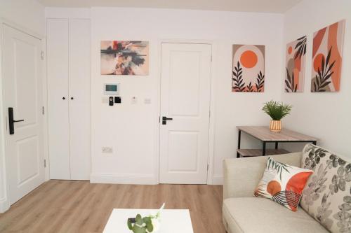 a living room with a couch and a table at Luxury 1 bed flat London in Mitcham