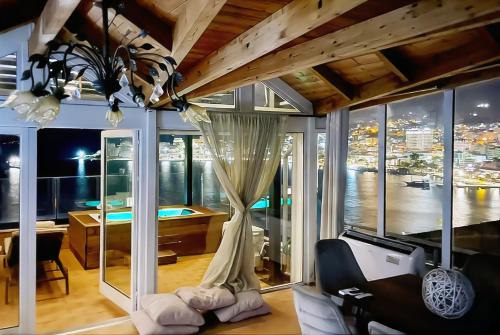 a room with a large window with a desk and a room with a treadmill at Paris Luxury Penthouse in Sarandë