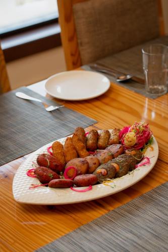 a plate of sausages and other foods on a table at Spectrum Resort, Spa & Residences in Udaipur